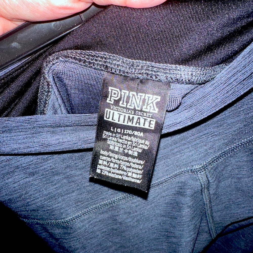 Dark gray spandex leggings. They have strips on the front of the legs